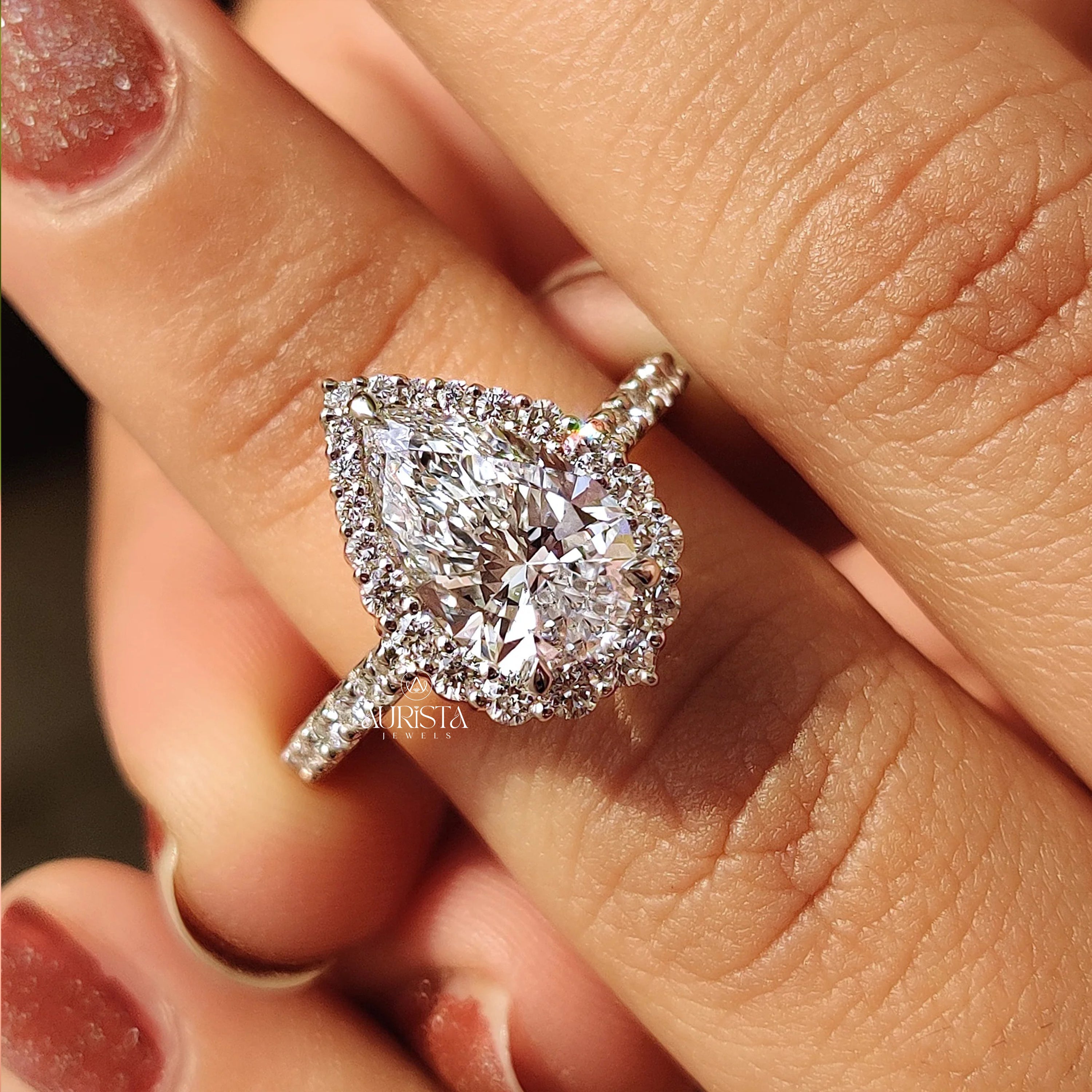 Eternal Pear Cut Halo Ring with Dazzling Side Stone Elegance