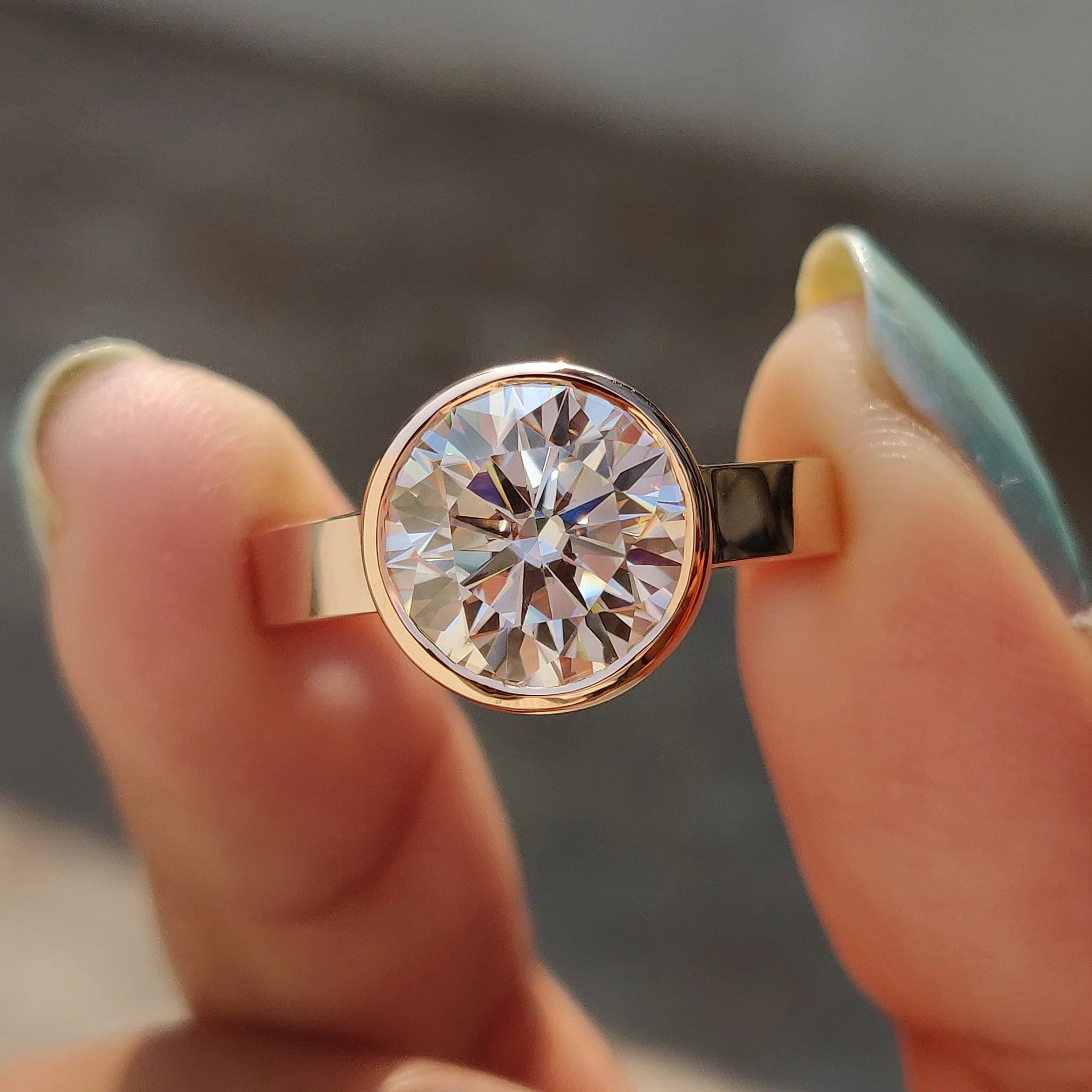 Round Cut Moissanite Bezel Set Solitaire Engagement Ring in Rose Gold Minimalist Band