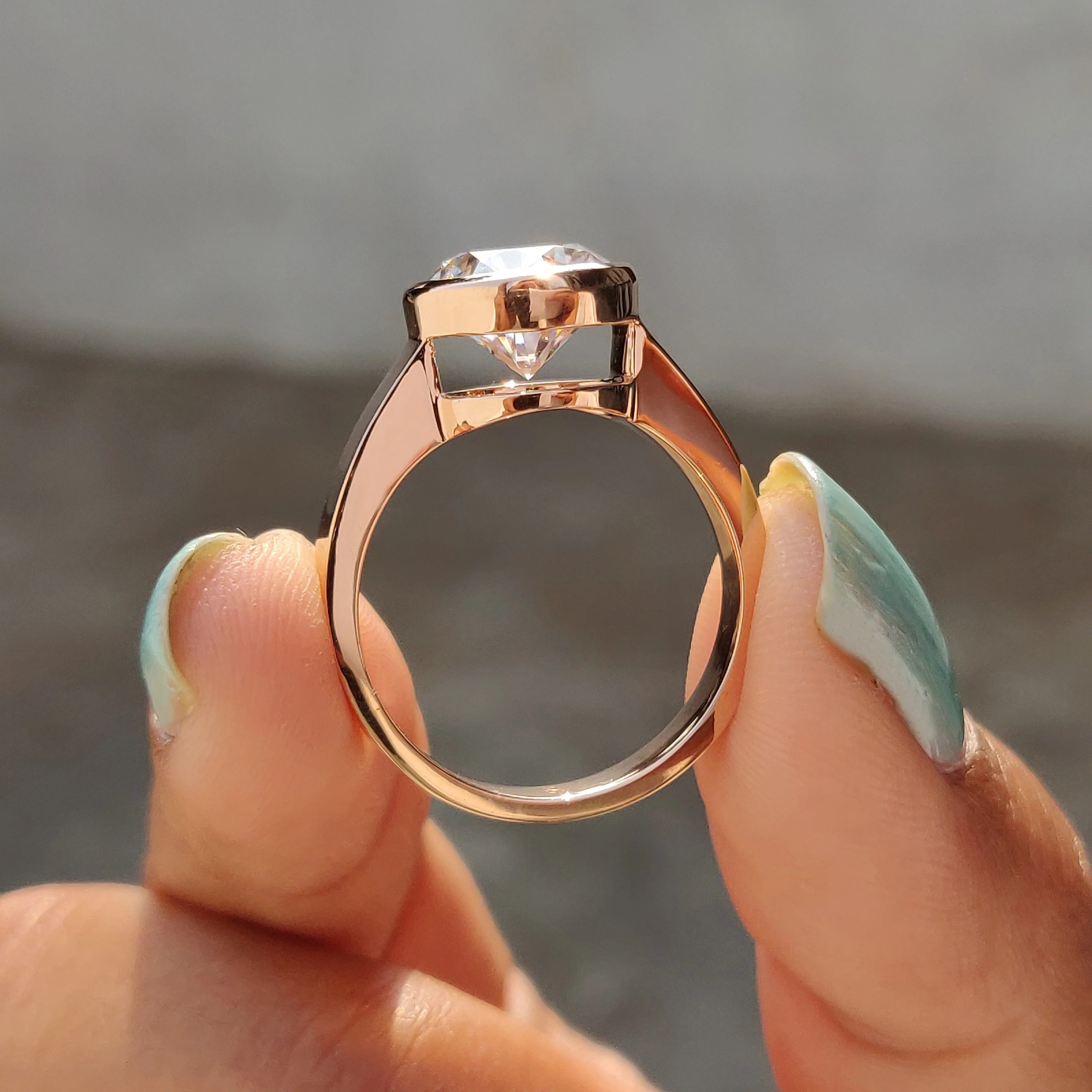 Round Cut Moissanite Bezel Set Solitaire Engagement Ring in Rose Gold Minimalist Band