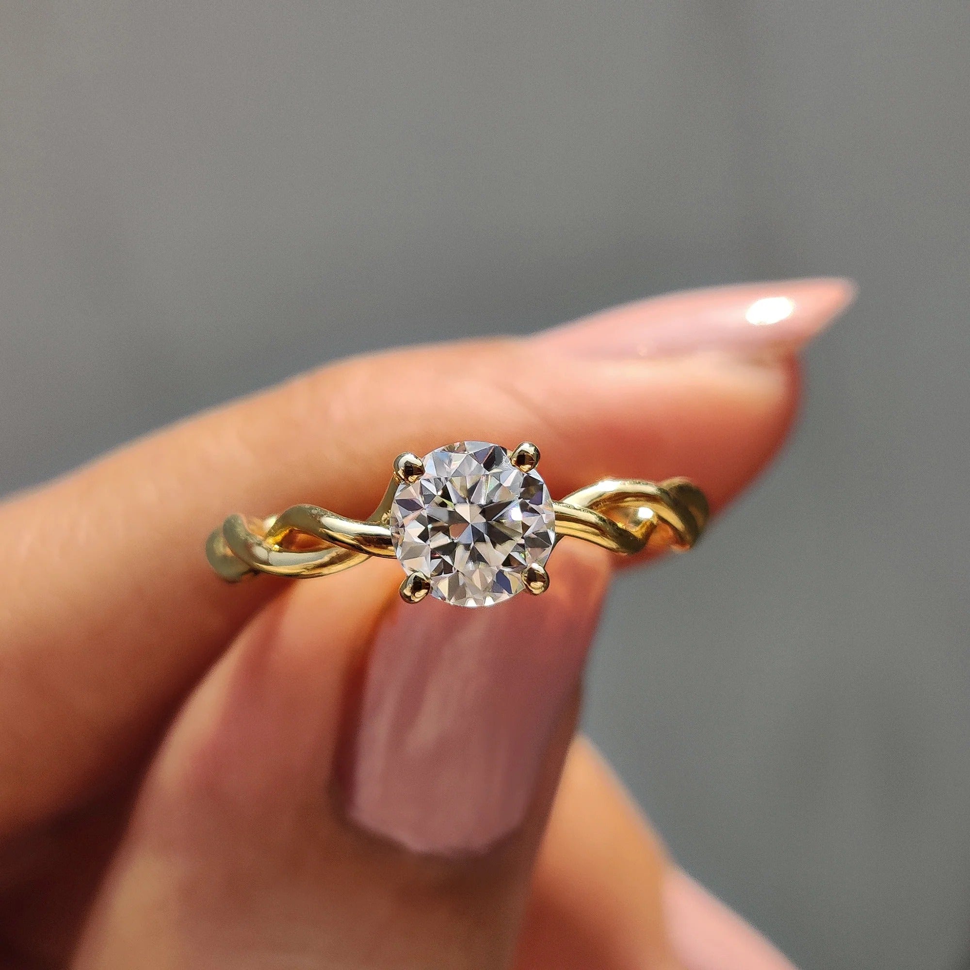 Round Moissanite Engagement Ring with Twisted Yellow Gold Band for Unique Proposals