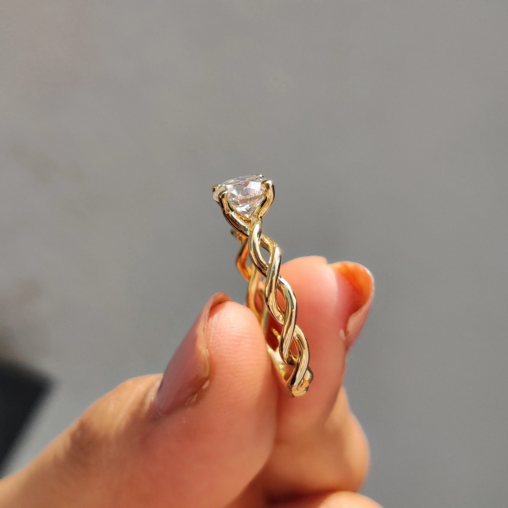 Round Moissanite Engagement Ring with Twisted Yellow Gold Band for Unique Proposals