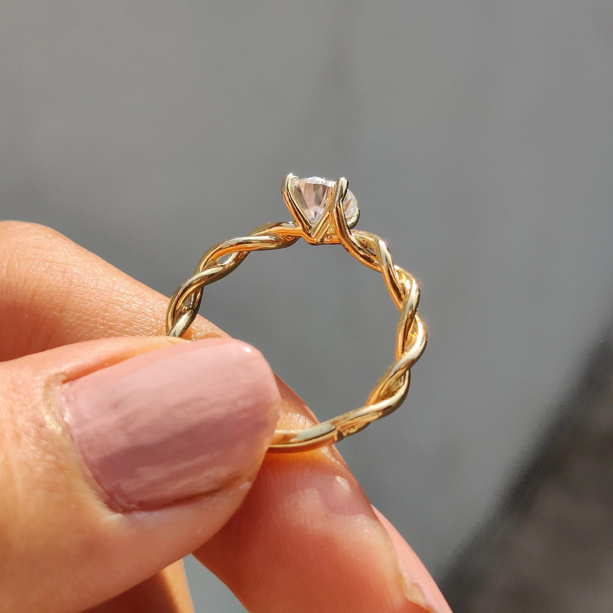 Round Moissanite Engagement Ring with Twisted Yellow Gold Band for Unique Proposals