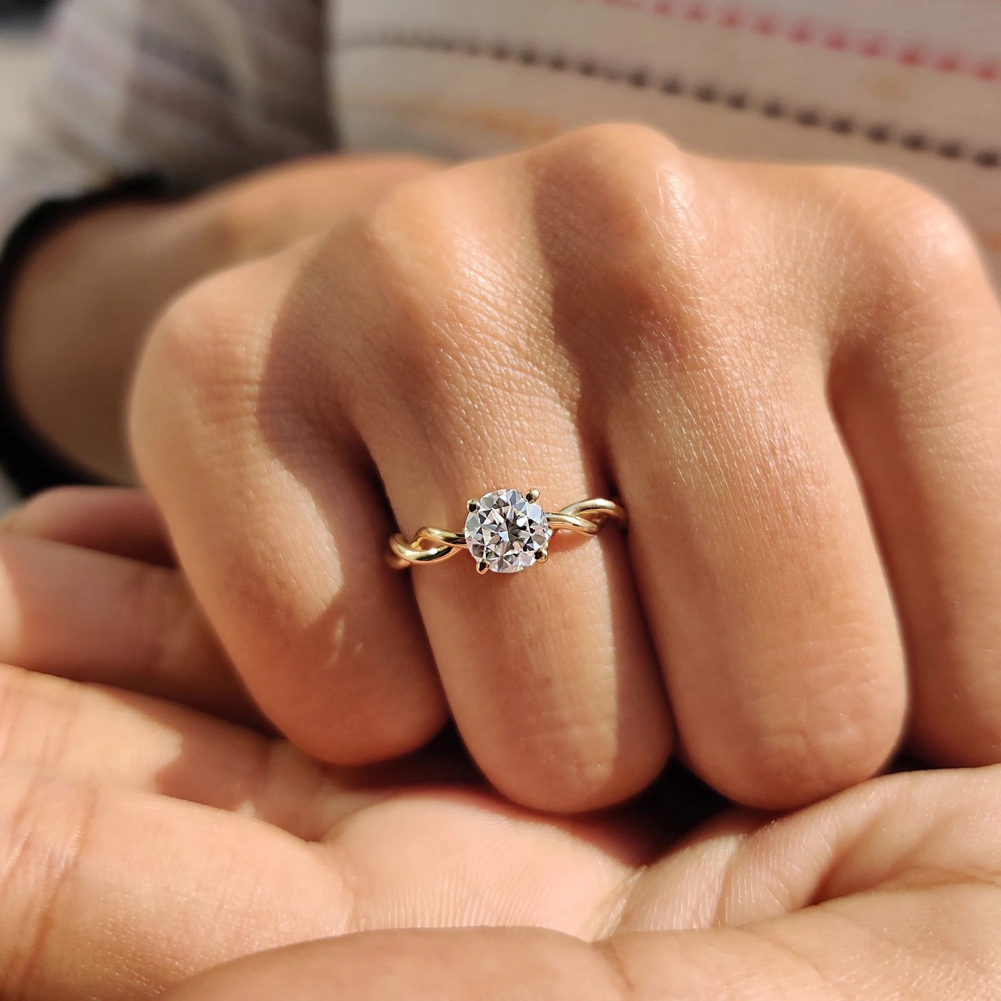 Round Moissanite Engagement Ring with Twisted Yellow Gold Band for Unique Proposals