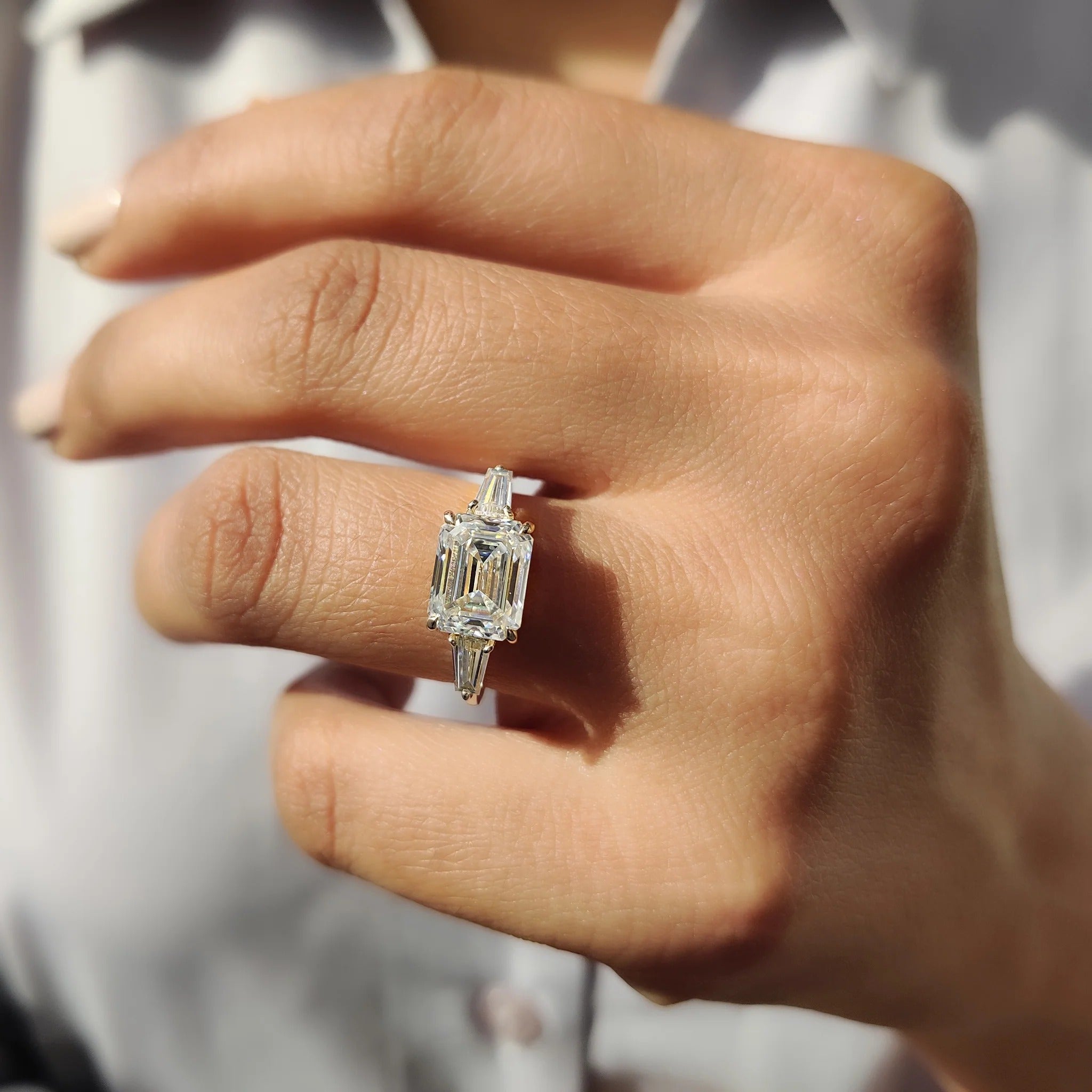Emerald Cut Moissanite Three-Stone Engagement Ring with Tapered Baguette Side Stones