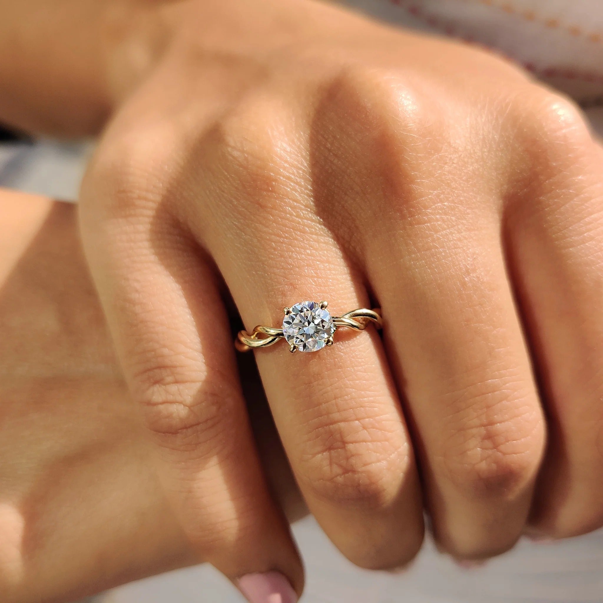 Round Moissanite Engagement Ring with Twisted Yellow Gold Band for Unique Proposals