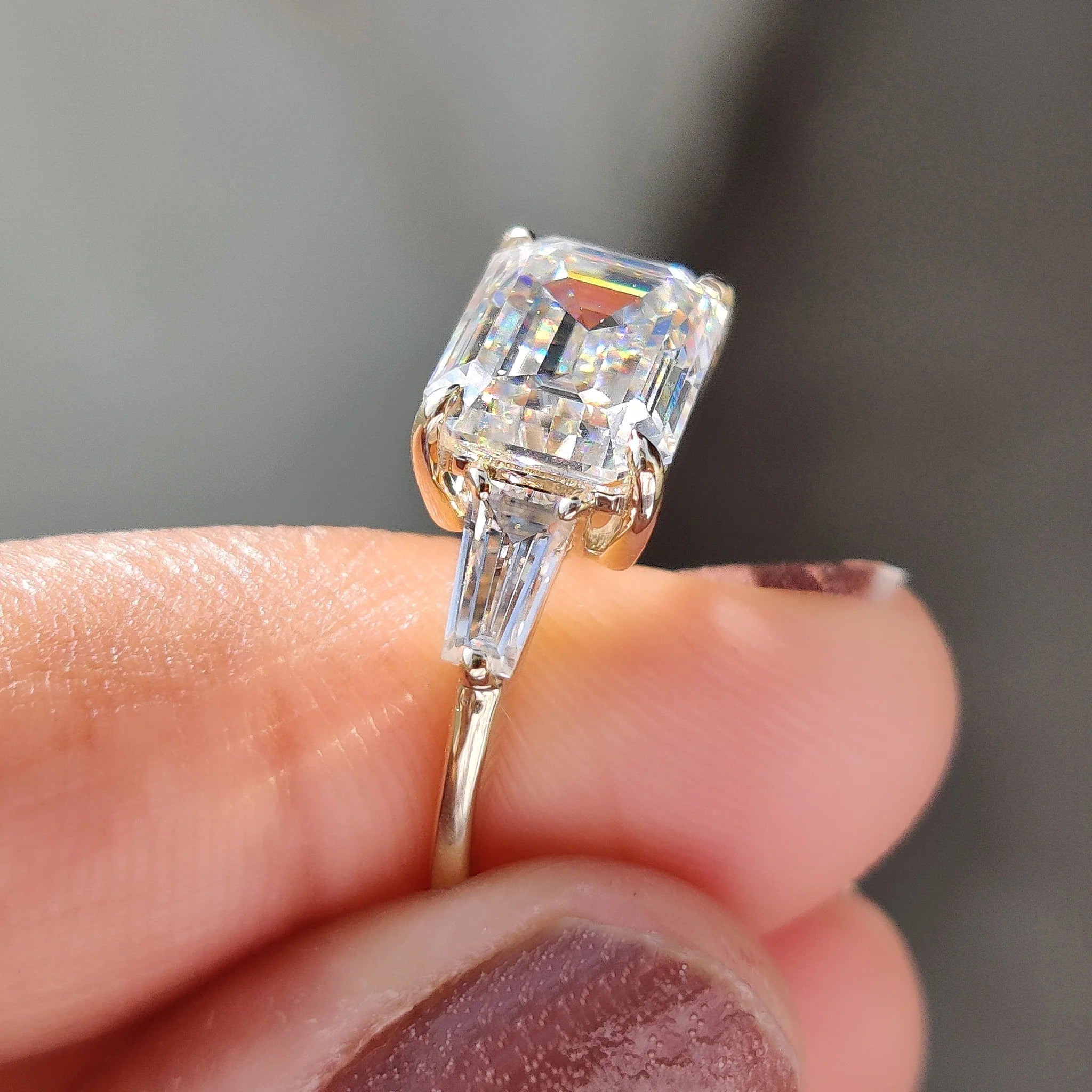 Emerald Cut Moissanite Three-Stone Engagement Ring with Tapered Baguette Side Stones